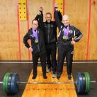 Fitness trainer Jeff Leckie (centre) celebrates gold medal-winning athletes Ryan Stewart (left),...