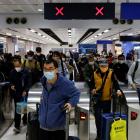 Travellers arrive at Hong Kong's Lok Ma Chau border checkpoint on the first day China reopens the...