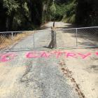 Gates and spray-painted messages are deterring cyclists on a partially completed section of the...