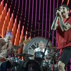 Members of Red Hot Chili Peppers (from left) Flea,  Chad Smith and Anthony Kiedis  perform in...