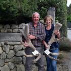 Tikana Wapiti Stud owners Dave Lawrence and Donna Day hold the trophy head of bull Hawk, which...