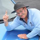 Veteran Dunedin umpire John Henderson with his number plate OUTLBW, celebrating 39 years of...