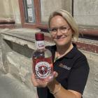Laura Byars, from the New Zealand Whisky Collection, with a bottle of Spirit of Munro vodka being...