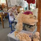 Artist Lissie Brown works on her Eve sculpture at her home in Brighton. Her breast ‘‘flower’’ and...
