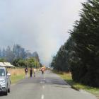 Emergency services block the road as they try to extinguish a vegetation fire near Winton. PHOTO:...