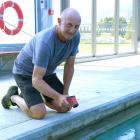 West Otago Swimming Pool committee president Barry Frew tests the temperature of the Tapanui pool...