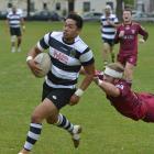 Southern centre Paul Tupai slips away from the tackle of Alhambra-Union flanker Tom Frood at the...