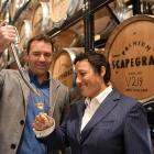 Scapegrace Distilling co-founder Daniel Mclaughlin pours a sample of the company’s single malt...