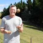 Dung Beetle Innovations co-owner Shaun Forgie, of Auckland, holds a manure ball once buried by a...