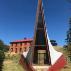 The sail-shaped chapel on Quarantine Island (Kamau Taurua) with the 1873 married quarters behind...