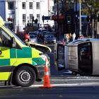 An ambulance is damaged and a car is on its side after the two vehicles collided in central...
