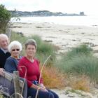 Kaka Point neighbours (from left) Ian and June Kreger and Michelle Rutherford sit on a bench they...