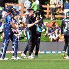 Black Caps paceman Adam Milne (third from left) is congratulated by team-mates (from left) Daryl...