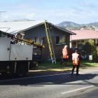 Contractors work to restore a power line which was downed by a truck in Blueskin Rd, Port...