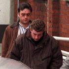 Gareth Smither (front) leaves the Dunedin courthouse after appearing on a murder charge in July...