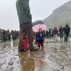 Rosie Stewart (2) shelters under an umbrella at calf sale at Matukituki Station, which her...