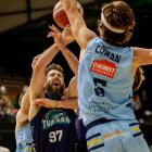 Otago Nuggets forward Robbie Coman gets up to defend Auckland Tuatara player Jarrad Weeks during...