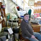 West Otago Vintage Club president Dan Meeklah sits amidst some of the club’s "cramped" collection...
