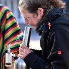 Protester Juz Page rips a bong at Dunedin's annual J Day protest on Saturday. PHOTO: STEPHEN...