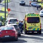 Police and ambulance officers assist a man into an ambulance after he was assaulted following a...
