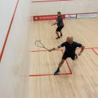 Ty Adams (left), of the Wanaka Squash Club, pursues the ball in a match against fellow club...
