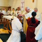 Catholic Bishop of Dunedin Michael Dooley ordains Iosefa Setu (kneeling), of Balclutha, as a...