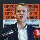 Prime Minister Chris Hipkins speaks to University of Otago students, in front of a backdrop of...
