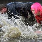  Kate Roberts (left), Jesse Gray and Sasha Williams take on the Mud, Sweat and Tears Challenge at...
