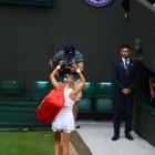 Victoria Azarenka gestures as she leaves the court after losing to Ukraine's Elina Svitolina....