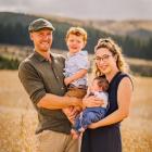 Rob Hewett, holding son Walter, and Helena Robinson with baby Ted, on their Dunback farm. Photo:...