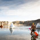 Francois Lambrechts, of Dunedin, enters the water to start his swim at the International Ice...