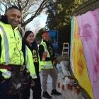 Painting a mural in Anzac Ave for the Fifa Women’s World Cup are (from left) Graham Hoete, who...