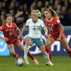 New Zealand's CJ Bott finds herself under pressure from Swiss players Geraldine Reuteler (left)...