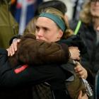 Grace Jale hugs a family member after the 0-0 draw confirming the elimination of the Football...