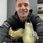Dan Carter with a pair of his limited edition Adidas boots. Photo: Supplied