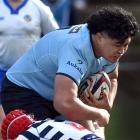 King’s prop Philjoseph Elisara tries to bust the tackle of Otago Boys’ lock Matthew Attenborough...