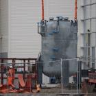 Mataura Valley Milk’s new electrode boiler is lifted by a crane so it can be lowered through the...