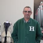 Hokonui Fashion Design Awards judge Steve Dunstan stands beside a display of the garments...