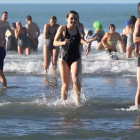 Swimmers head back to the warmth of a towel after their cold plunge at the Waikuku Beach Surf...
