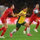 Australia's Sam Kerr is held back by Denmark's Simone Boye Sorensen. Photo: Reuters