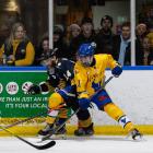 Stampede forward Axel Ruski-Jones, in yellow, jets to the United States to play ice hockey in...