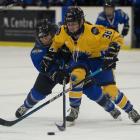 Wakatipu Wild forward Polly Bennetts is put under pressure from Auckland defenceman Jamieson...