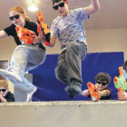 Ella Rothschild-Stewart and Fergus Webb, both 10, leap over one of the obstacles at the Nerf...