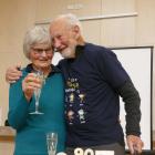 Barb Simpson raises a glass with her husband, Neill, at his surprise 90th birthday party in...