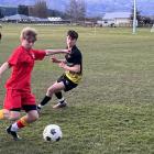 Nate Unsworth (Dunstan, left) tries to beat Zavier Taylor (Mount Aspiring College) during an...