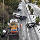Vehicles litter Stuart St following a downpour of ice and snow on Wednesday night. 