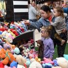 Aila Jones, 4, sister Miya, 1, and mother Jess Jones marvel at the hundreds of tiny teddies on...
