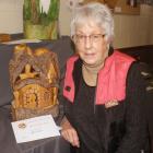 Southland Woodworkers Guild member Bev Wilson with a carved tree house in 2021. PHOTO: Southland...
