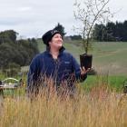 Sandra Campbell with a kowhai tree grown in her South Otago on-farm native nursery. PHOTO:...