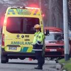 An emergency services officer attends a crash in Cumberland St, in Dunedin, on Sunday where a...